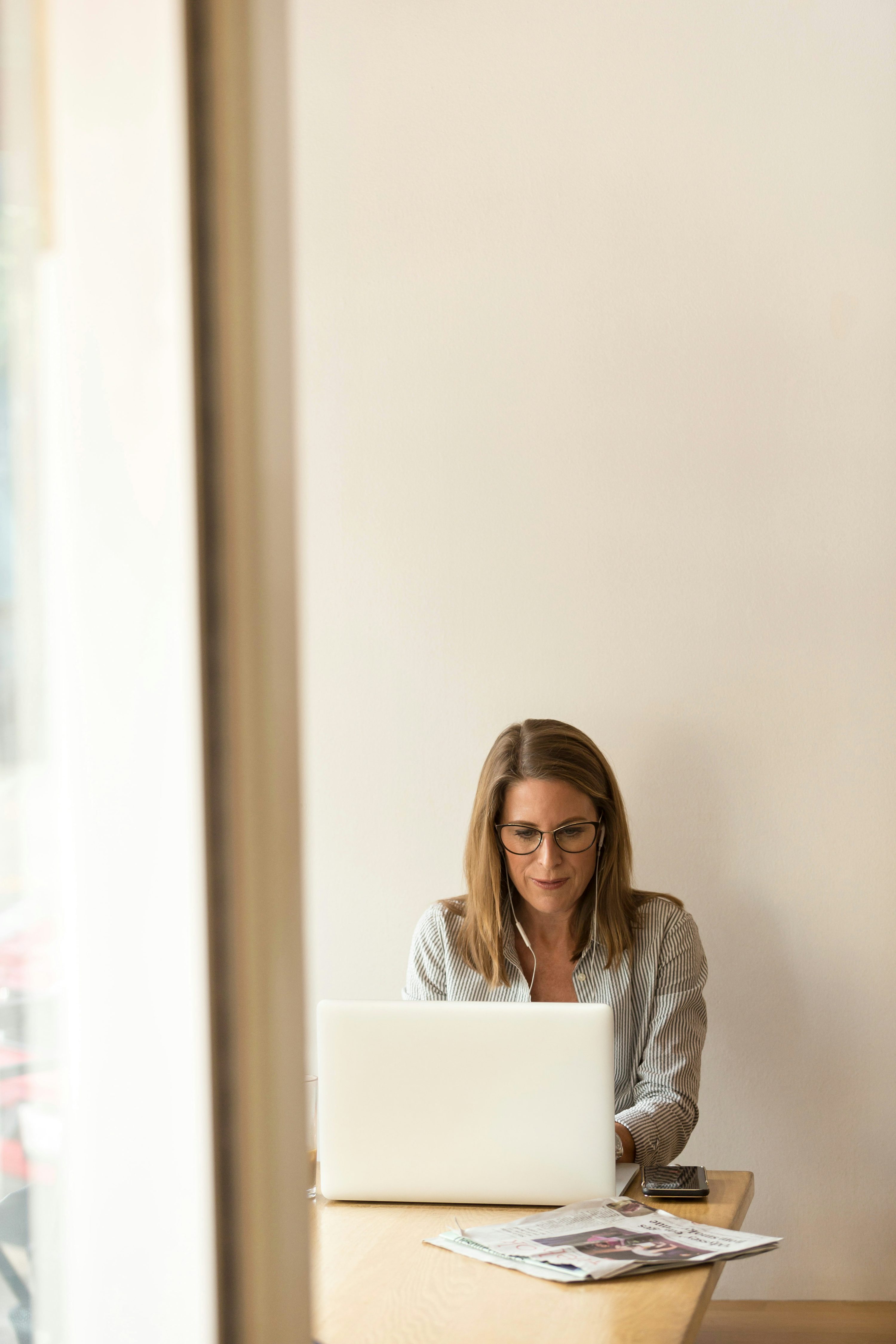 A professional tutor working at a laptop in a calm home setting